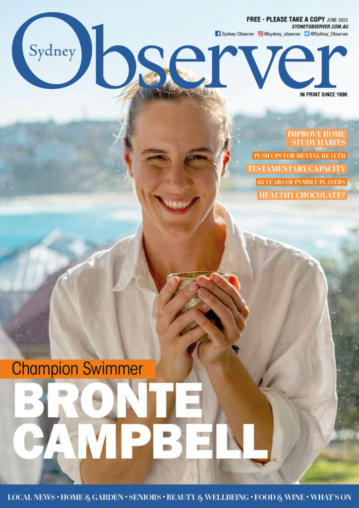Sydney Observer June cover with Swimmer Bronte Campbell smiling andholding a mug in a balcony in front of the beach